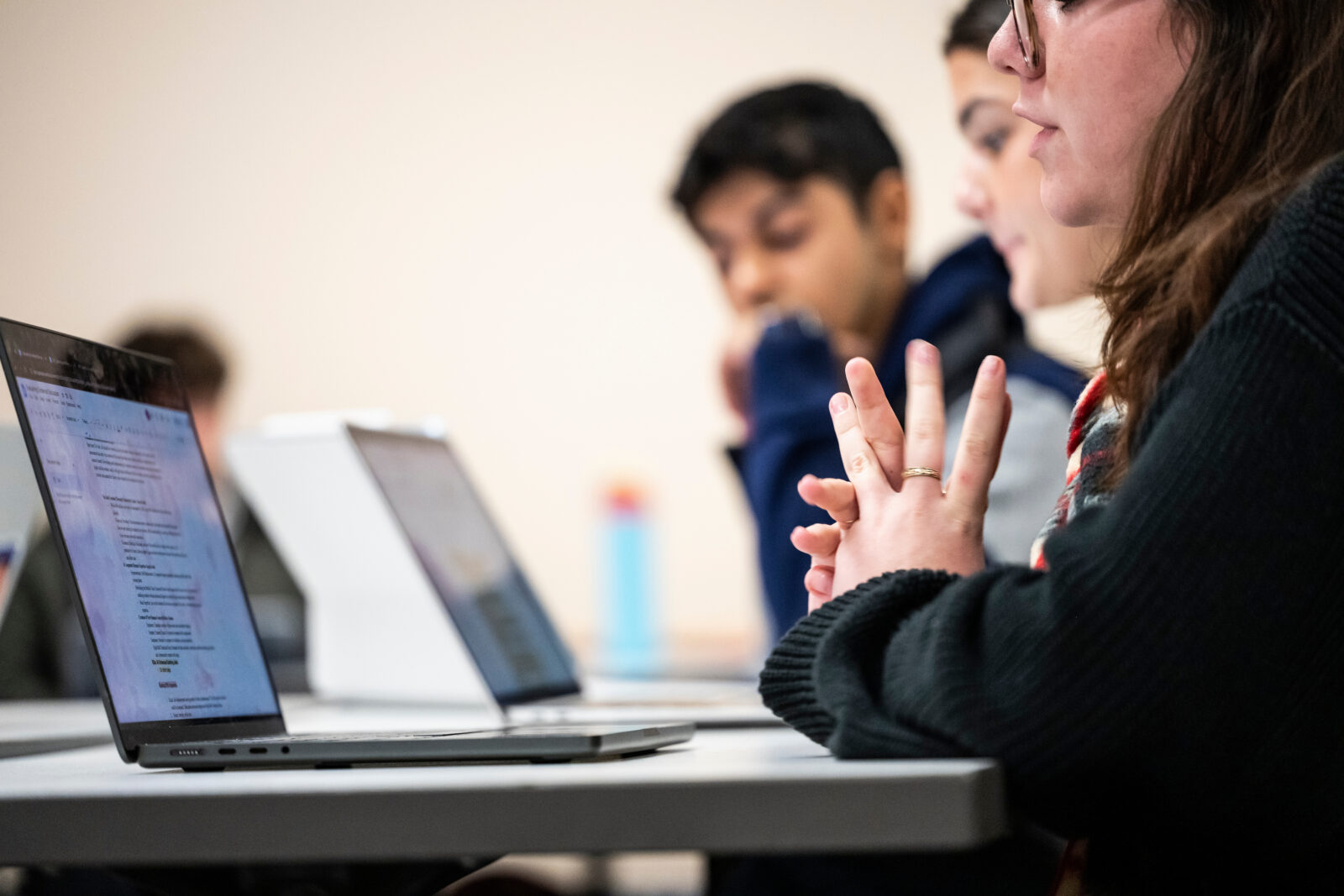 People discussing while using laptops