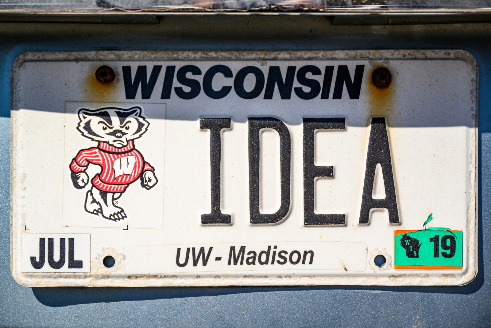 A car license plate displaying the words "Wisconsin Idea".